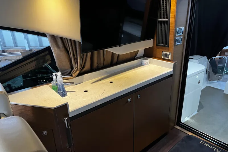 Slide: The Image of Interior view of 2015 Sea Ray 510 Sundancer yacht docked at a marina. - 32