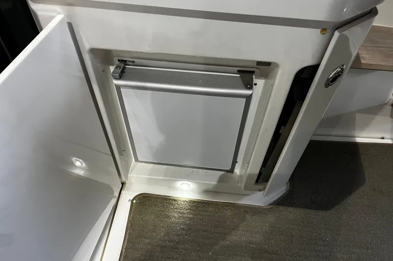 Slide: The Image of Control panel of 2015 Sea Ray 510 Sundancer yacht with navigation screens and steering wheel. - 34