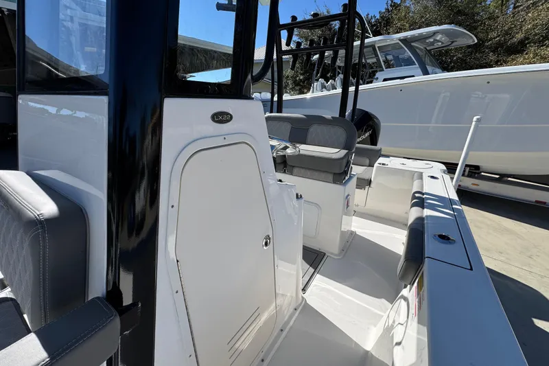 Slide: The Image of 2026 Sea Born LX22 Center Console boat interior with seating and console details. - 26