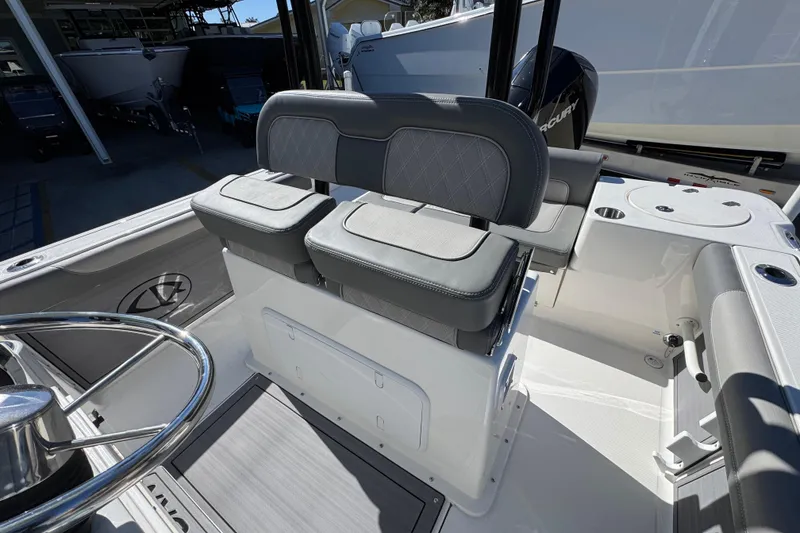 Slide: The Image of 2026 Sea Born LX22 Center Console boat interior with dual seating and steering wheel. - 28