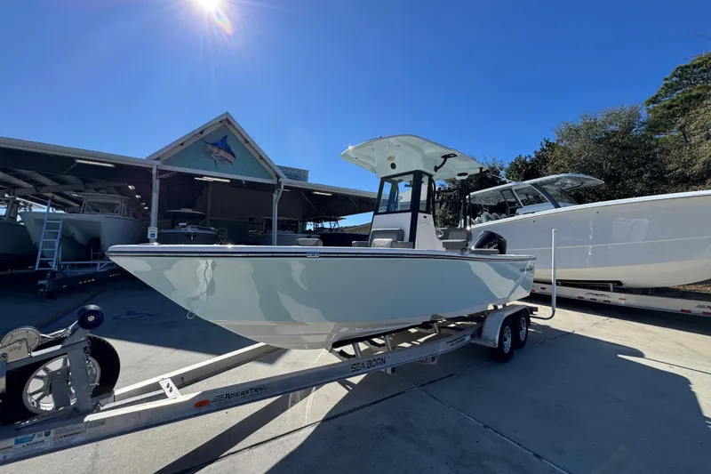 Slide: The Image of 2026 Sea Born LX22 Center Console boat on trailer under clear blue sky. - 3