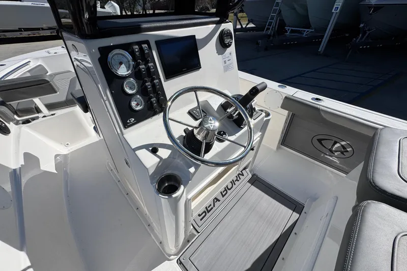 Slide: The Image of 2026 Sea Born LX22 Center Console boat interior with steering wheel and control panel. - 31