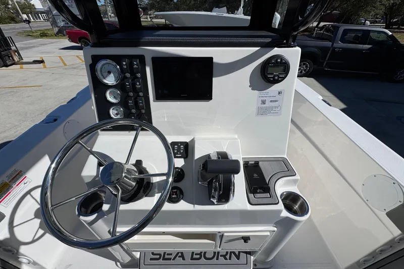 Slide: The Image of 2026 Sea Born LX22 Center Console boat dashboard with steering wheel and controls. - 32
