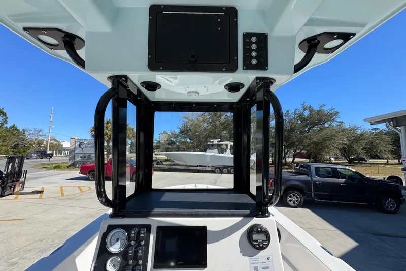 Slide: The Image of 2026 Sea Born LX22 Center Console boat dashboard with gauges and controls, parked outdoors. - 33
