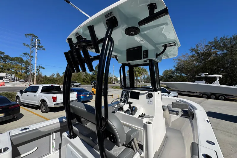 Slide: The Image of 2026 Sea Born LX22 Center Console boat with modern helm, parked outdoors. - 37