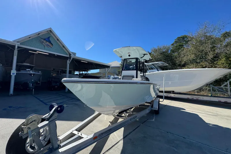 Slide: The Image of 2026 Sea Born LX22 Center Console boat on trailer under clear blue sky. - 4