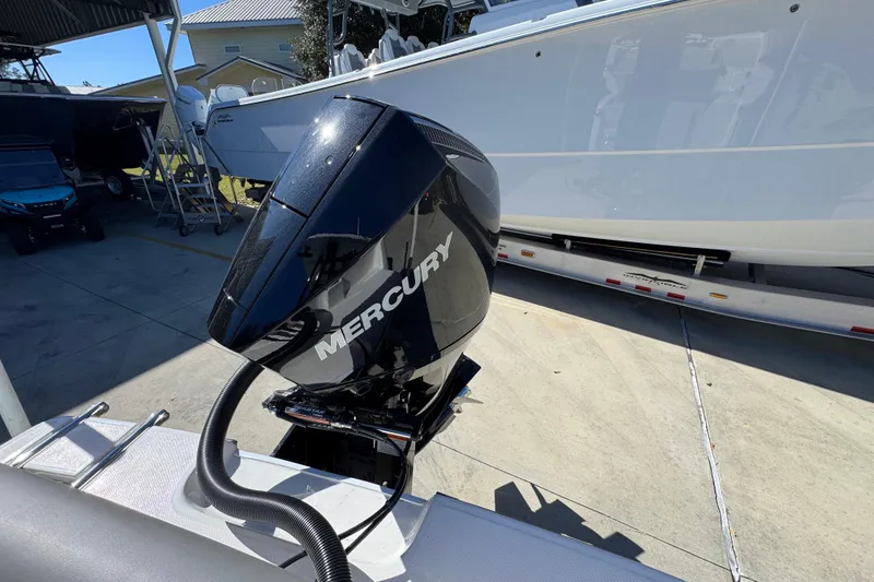 Slide: The Image of 2026 Sea Born LX22 Center Console with Mercury outboard engine in a marina setting. - 40