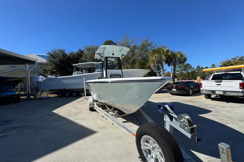 Slide: The Image of 2026 Sea Born LX22 Center Console boat on trailer in sunny outdoor setting. - 6