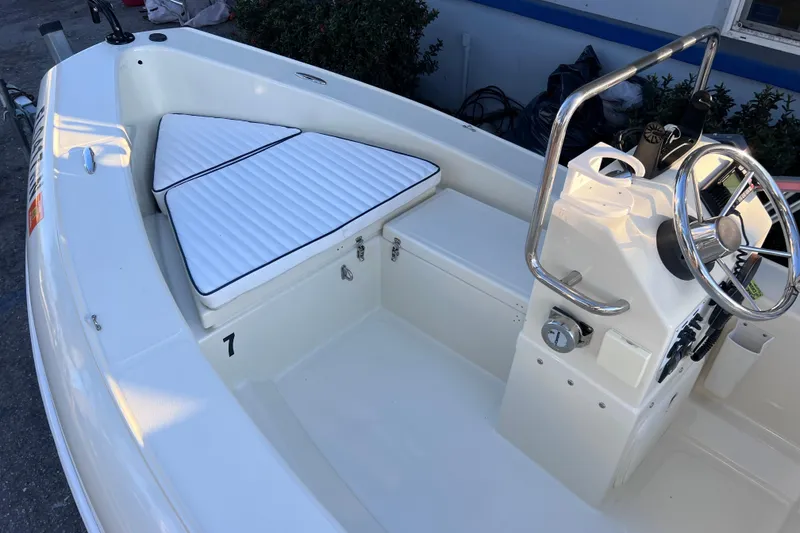 Slide: The Image of 2017 Rigid Boats 14 Sport interior with steering wheel and cushioned seating. - 11