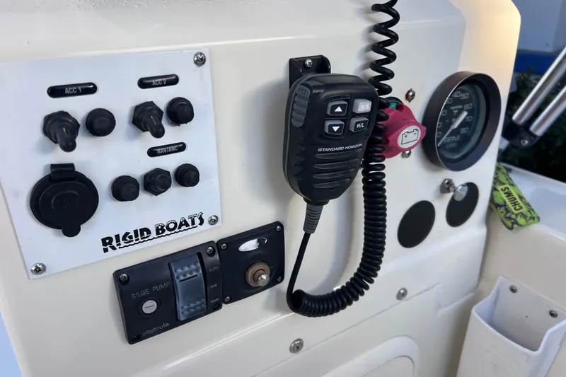 Slide: The Image of Control panel of a 2017 Rigid Boats 14 Sport with radio and gauges. - 13