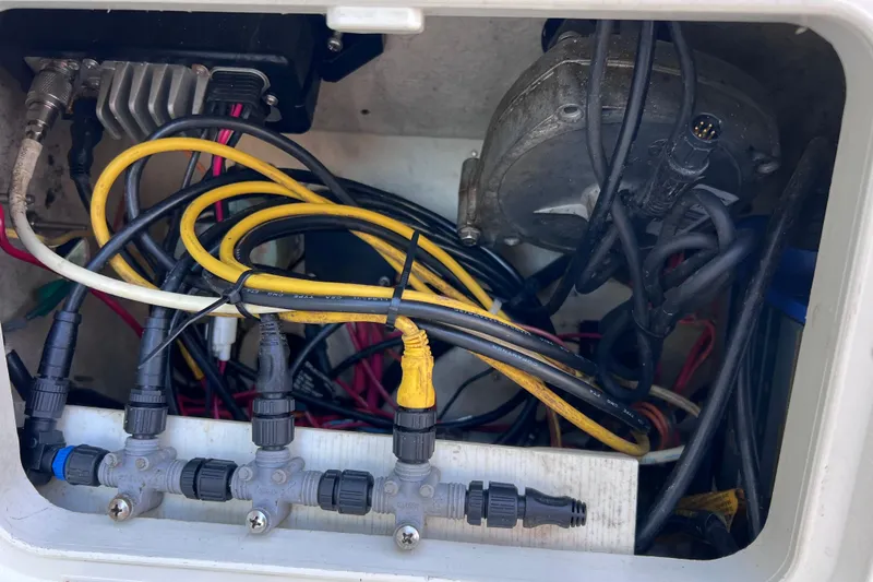 Slide: The Image of Electrical wiring inside a 2017 Rigid Boats 14 Sport, showcasing connectors and cables. - 15