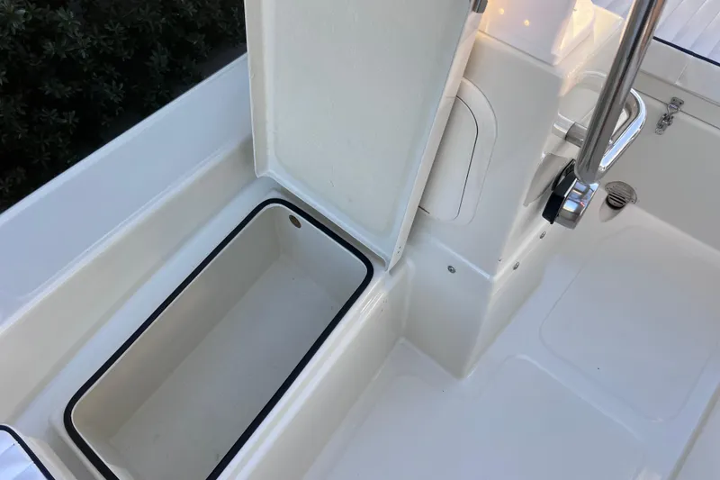Slide: The Image of 2017 Rigid Boats 14 Sport interior storage compartment with open lid. - 17