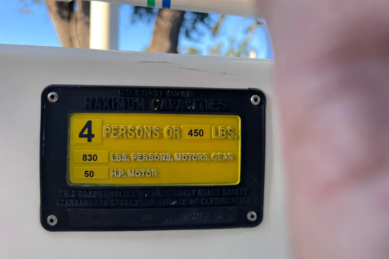 Slide: The Image of Capacity plate on 2017 Rigid Boats 14 Sport, showing limits for persons and motor. - 21