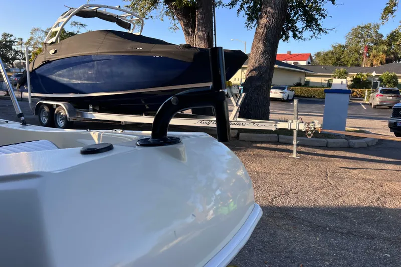 Slide: The Image of 2017 Rigid Boats 14 Sport on trailer, parked near trees and other vehicles. - 5