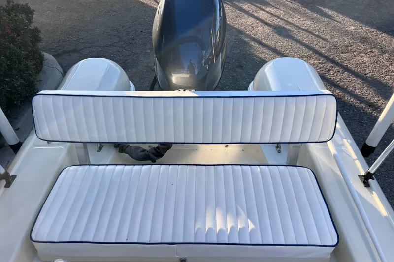 Slide: The Image of 2017 Rigid Boats 14 Sport with white cushioned seating and outboard motor. - 8