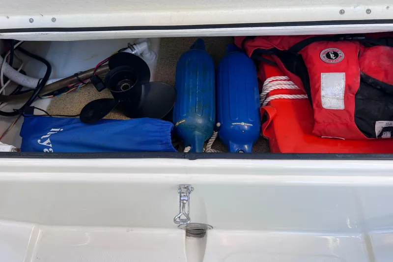 Slide: The Image of Storage compartment of a 2017 Rigid Boats 14 Sport with boating equipment and safety gear. - 9