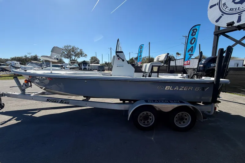 Slide: The Image of 2020 Blazer Bay 2200 Fisherman boat on trailer, displayed outdoors. - 10