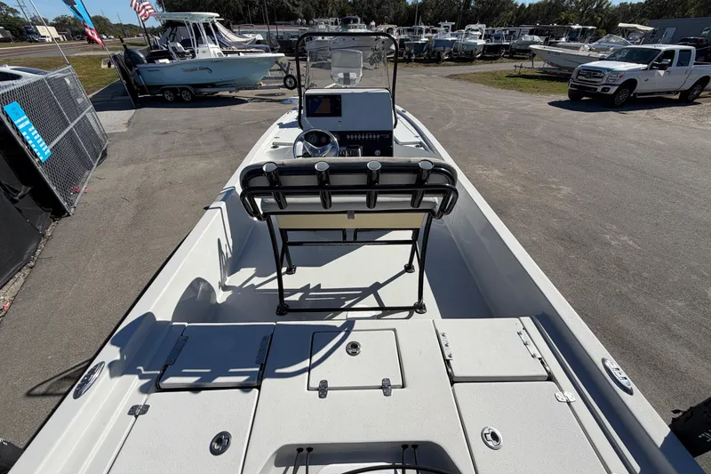 Slide: The Image of 2020 Blazer Bay 2200 Fisherman boat at a marina, showcasing deck and console. - 15
