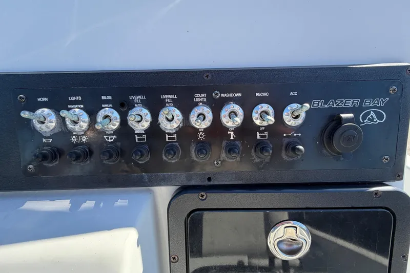 Slide: The Image of Control panel of 2020 Blazer Bay 2200 Fisherman boat with various switches and 12V outlet. - 23