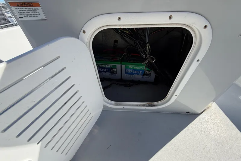 Slide: The Image of Open hatch on 2020 Blazer Bay 2200 Fisherman showing deep cycle battery storage. - 29