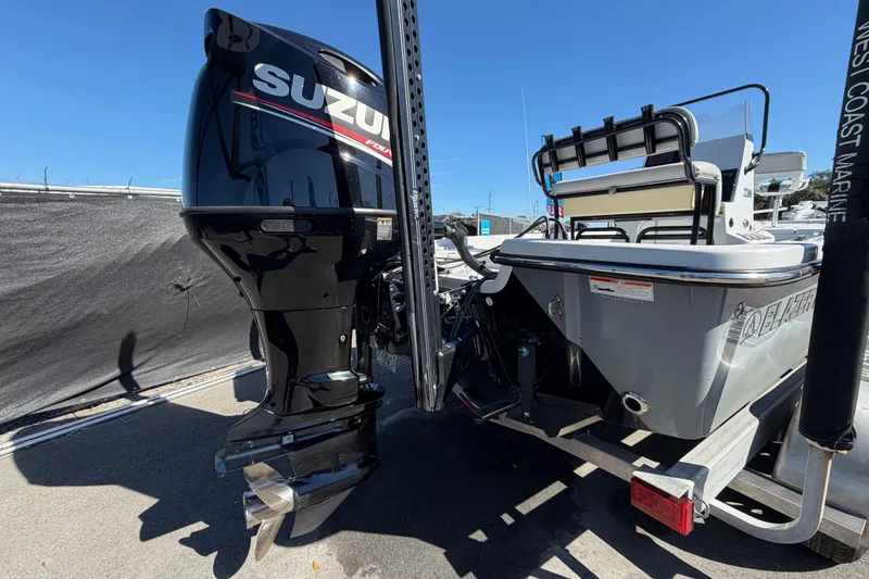 Slide: The Image of 2020 Blazer Bay 2200 Fisherman boat with Suzuki outboard motor, parked on trailer. - 4