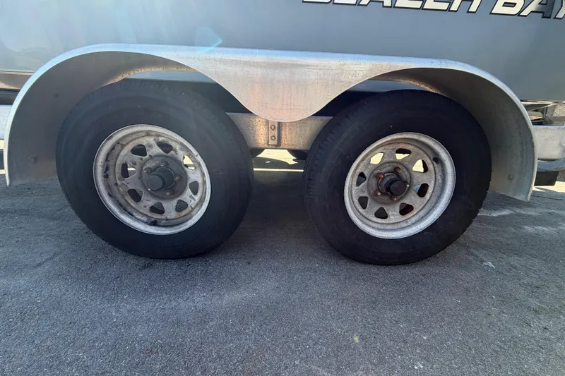 Slide: The Image of Trailer wheels of a 2020 Blazer Bay 2200 Fisherman boat on pavement. - 75