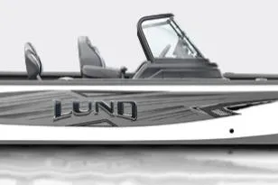 The Image of 2026 Lund 1875 Impact XS Sport boat on trailer, parked outside a building. - 0