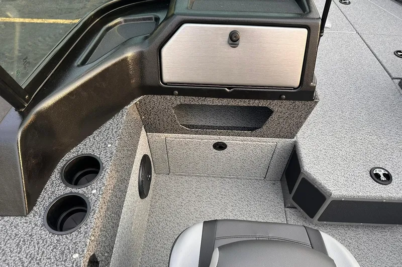 Slide: The Image of 2026 Lund 1875 Impact XS Sport boat interior with storage and cup holders. - 12