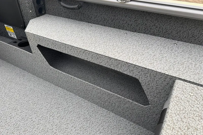 Slide: The Image of 2026 Lund 1875 Impact XS Sport boat interior with textured storage compartment. - 22