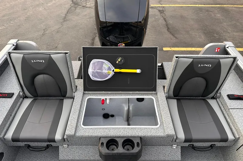 Slide: The Image of 2026 Lund 1875 Impact XS Sport boat interior with seating and storage compartments. - 9