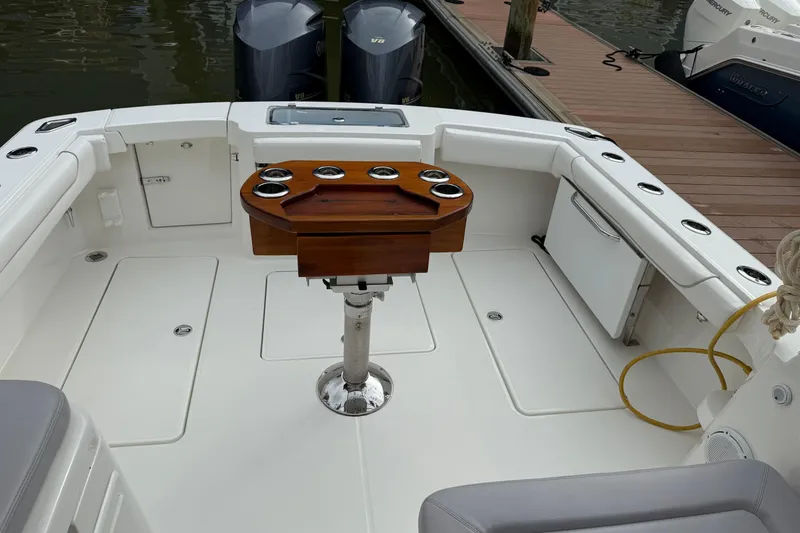 Slide: The Image of 2020 Albemarle 290 Express Fisherman boat interior with fishing rod holders and seating. - 10