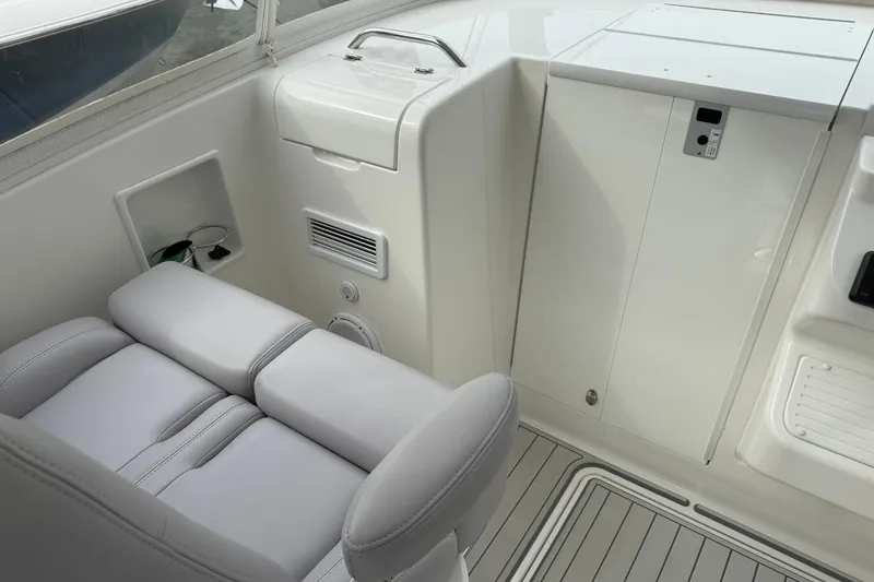 Slide: The Image of 2020 Albemarle 290 Express Fisherman interior with cushioned seating and storage compartments. - 19