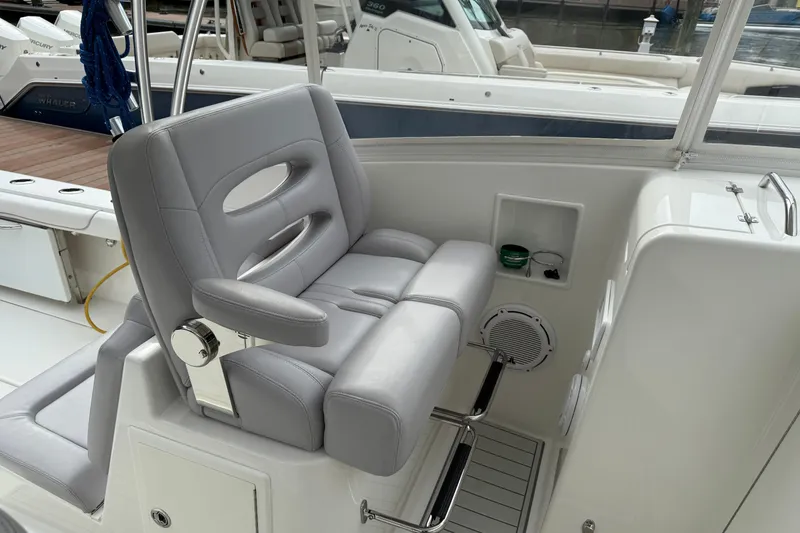 Slide: The Image of 2020 Albemarle 290 Express Fisherman boat interior with cushioned seating and storage compartments. - 21