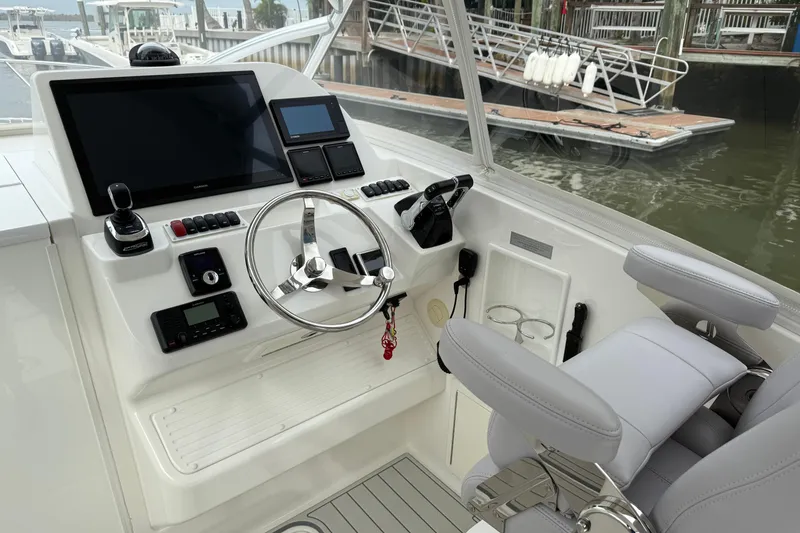 Slide: The Image of Helm of 2020 Albemarle 290 Express Fisherman with modern controls and navigation screens. - 29