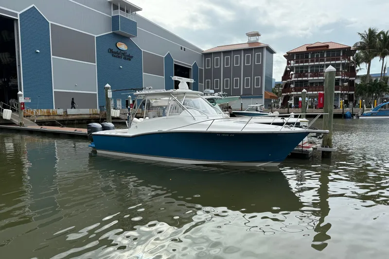 Slide: The Image of 2020 Albemarle 290 Express Fisherman docked at a marina with modern buildings. - 3