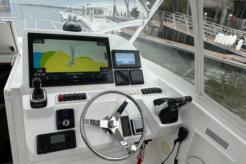 Slide: The Image of 2020 Albemarle 290 Express Fisherman helm with navigation screens and controls. - 31