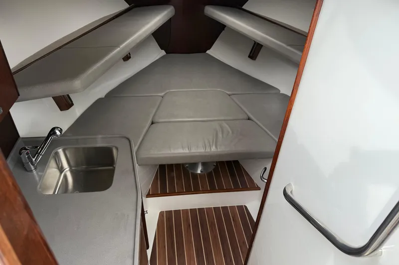 Slide: The Image of 2020 Albemarle 290 Express Fisherman cabin interior with sink and cushioned seating. - 32
