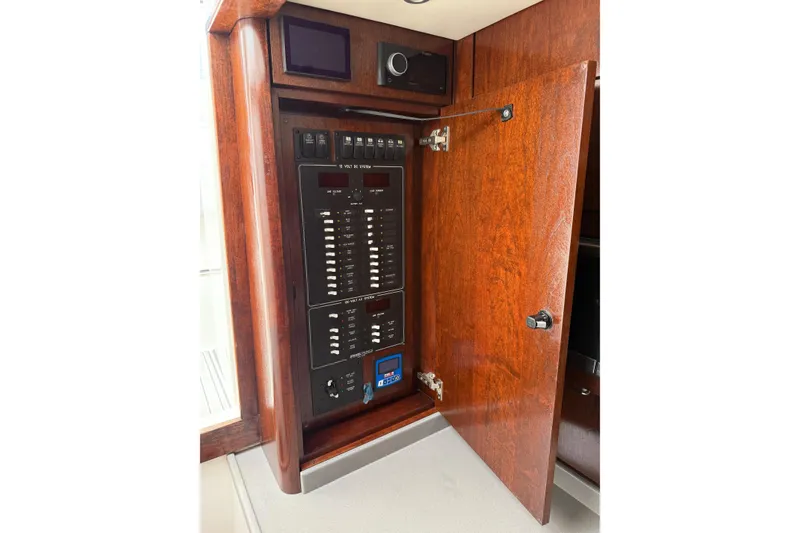 Slide: The Image of Electrical panel inside 2020 Albemarle 290 Express Fisherman boat, featuring wooden cabinetry. - 41
