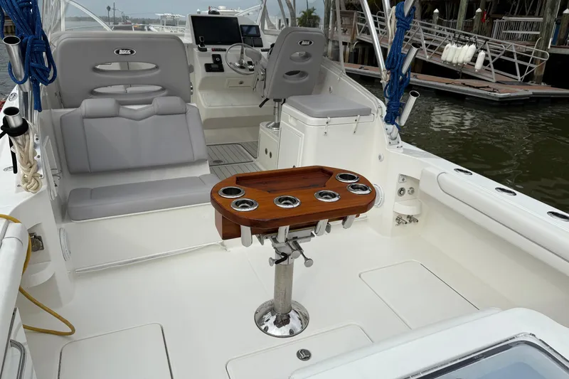 Slide: The Image of 2020 Albemarle 290 Express Fisherman boat interior with seating and fishing rod holders. - 9