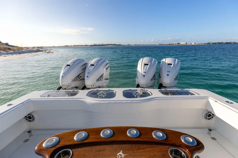 Slide: The Image of 2024 Freeman 47 boat with four powerful outboard engines on a serene ocean backdrop. - 11