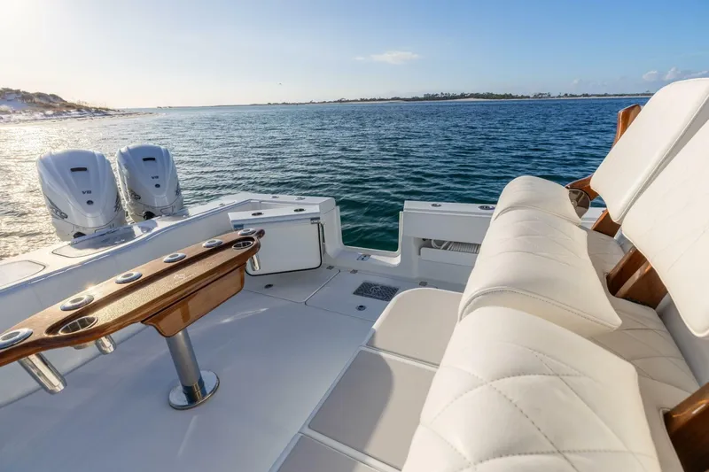 Slide: The Image of Luxurious 2024 Freeman 47 boat interior with plush seating and dual engines on open water. - 16