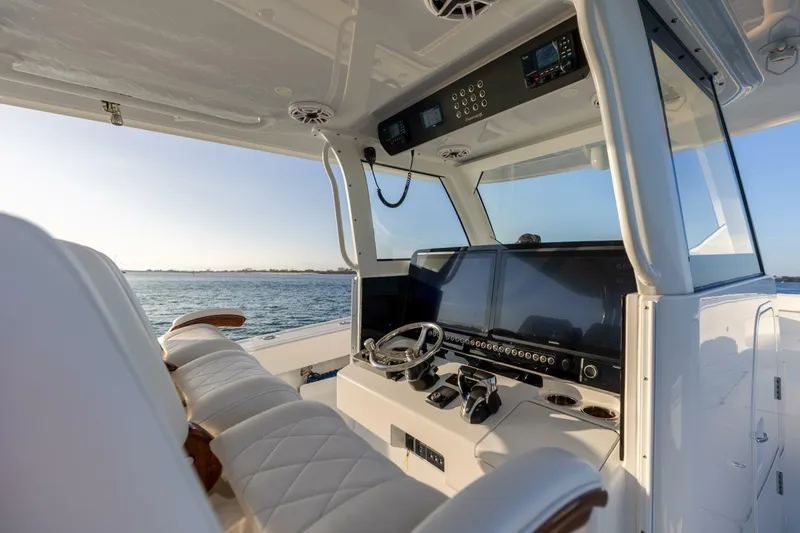 Slide: The Image of Luxurious 2024 Freeman 47 boat cockpit with advanced navigation systems and plush seating. - 19