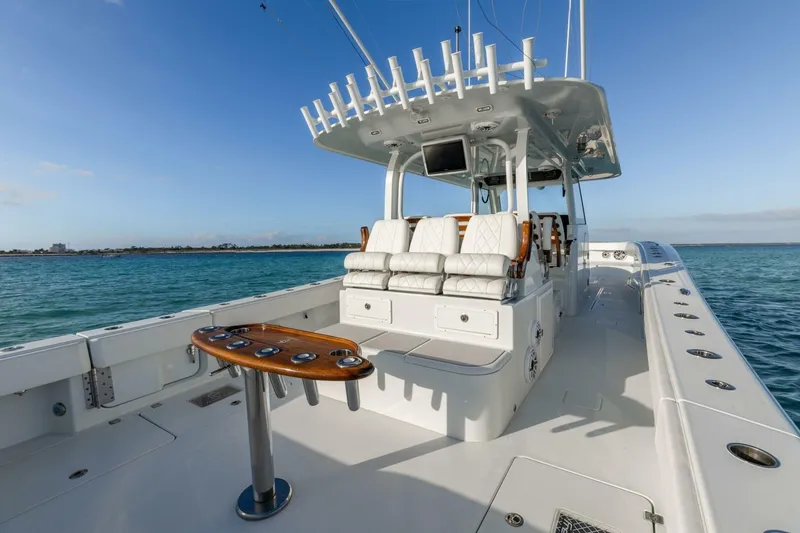 Slide: The Image of Luxury Freeman 47 boat, 2024 model, with spacious deck and seating on open water. - 2