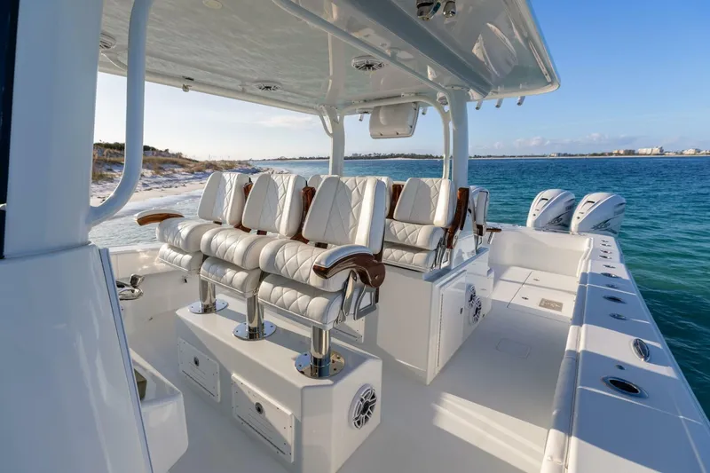 Slide: The Image of Luxury seating on a 2024 Freeman 47 boat, cruising in clear blue waters. - 20