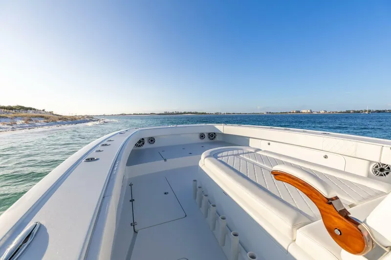 Slide: The Image of 2024 Freeman 47 boat interior with luxurious seating, cruising on a sunny day. - 21