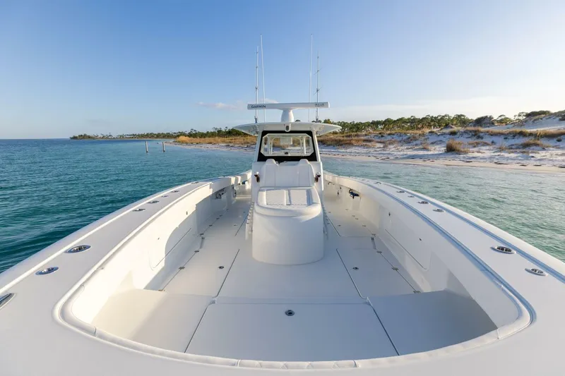 Slide: The Image of 2024 Freeman 47 boat on serene coastal waters, showcasing spacious deck and modern design. - 25