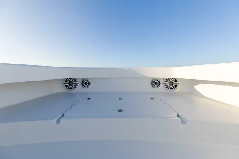 Slide: The Image of 2024 Freeman 47 boat deck with built-in speakers under clear blue sky. - 26