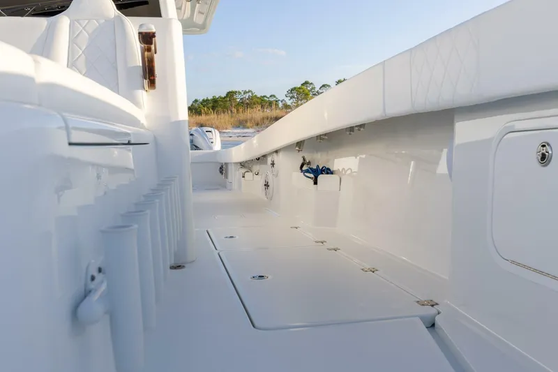 Slide: The Image of 2024 Freeman 47 boat interior with sleek white design and storage compartments. - 27