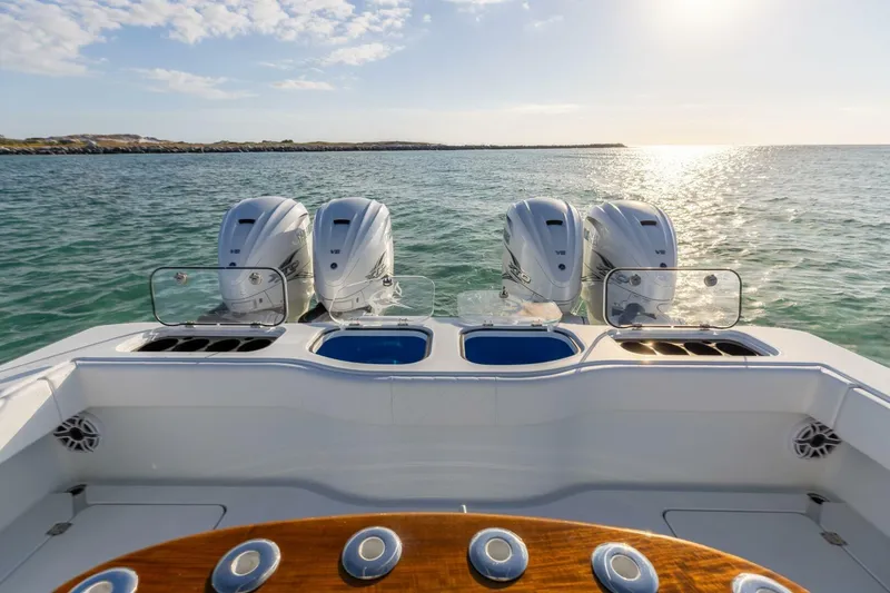 Slide: The Image of 2024 Freeman 47 boat with four powerful engines on open water. - 3