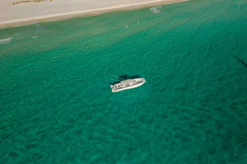 Slide: The Image of Aerial view of 2024 Freeman 47 boat on turquoise ocean near sandy beach. - 31